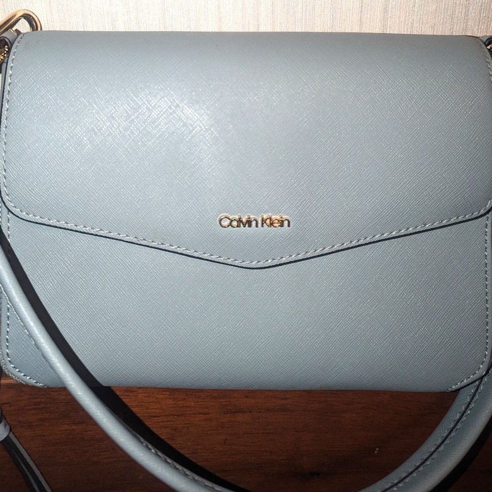Calvin Klein envelope style shoulder bag with magnetic closure.